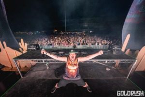 A DJ standing in front of a crowd at Goldrush: Wild Card