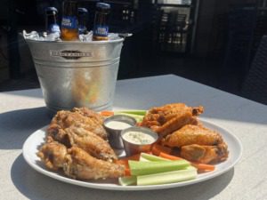 An ice cold bucket of beers with wings two-ways for Labor Day Weekend in Atlanta