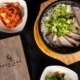 Table with plates of food from SsamJang Korean Barbecue