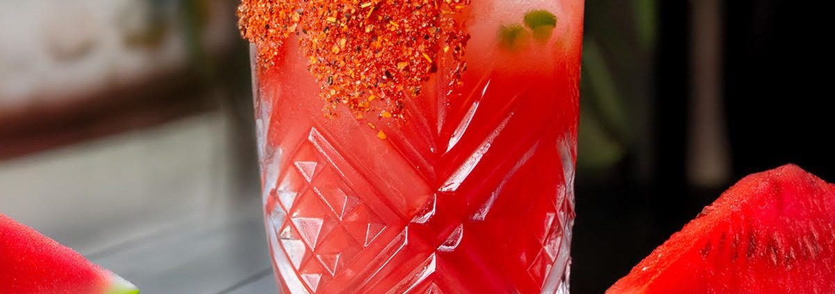 Watermelon drink in glass sitting on a table