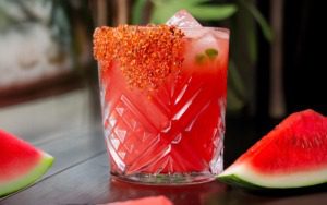 Watermelon drink in glass sitting on a table