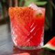 Watermelon drink in glass sitting on a table