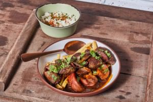 Table with plate of steak and fries