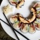Arial view of a portion of a plate of sushi with chop sticks