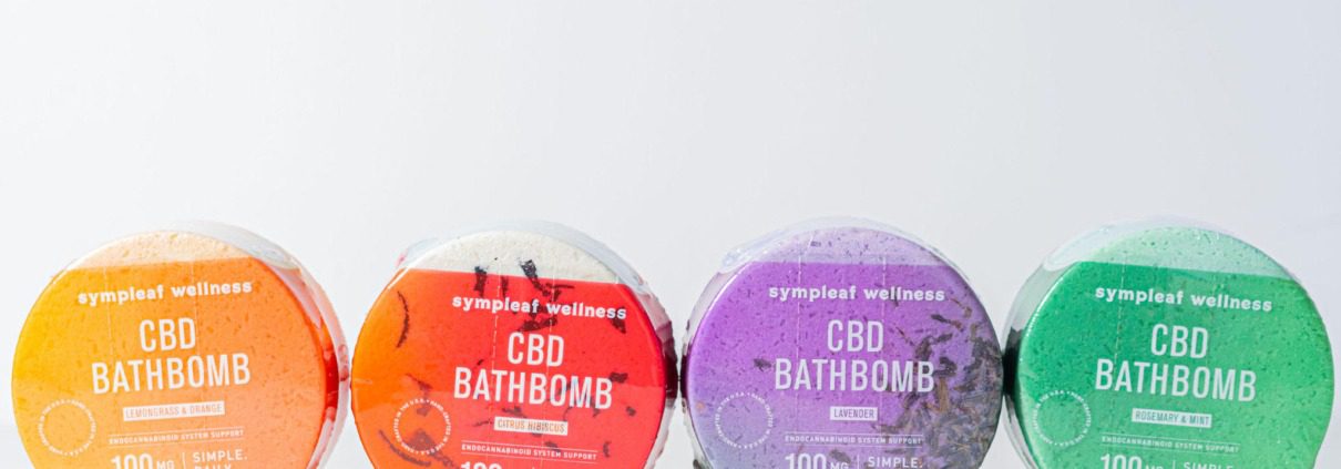 Four colorful CBD bath bombs on a white background