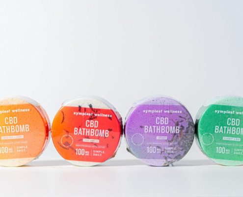 Four colorful CBD bath bombs on a white background