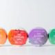Four colorful CBD bath bombs on a white background